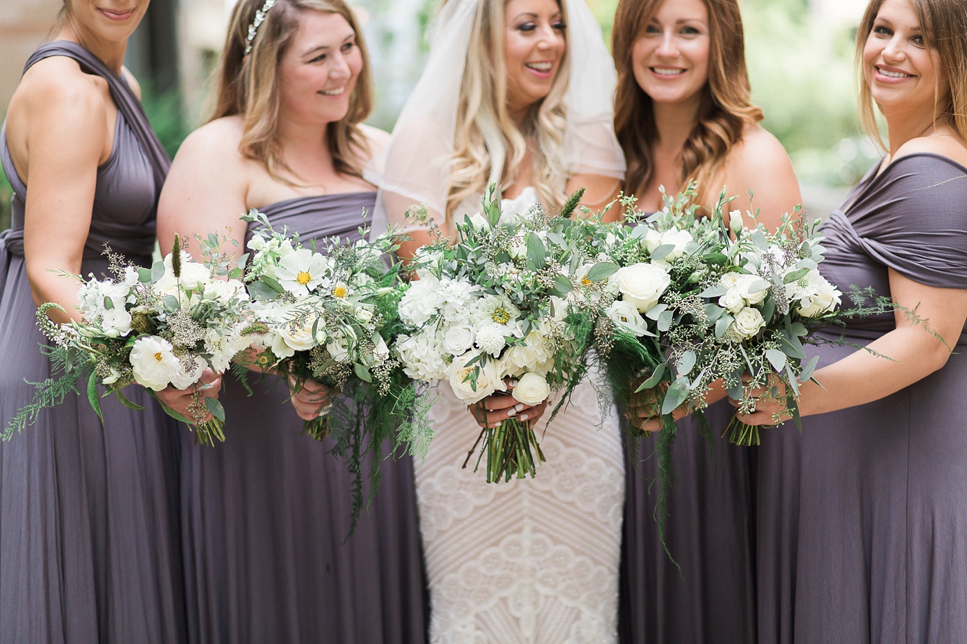 Seattle bride with bridesmaids in grey convertible dresses
